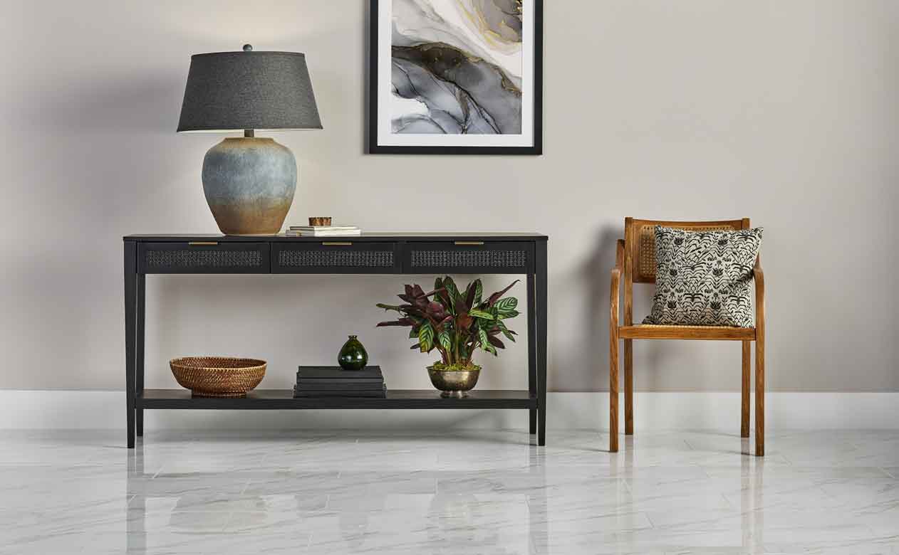 Living room with soft grey and cream furniture and carpet.