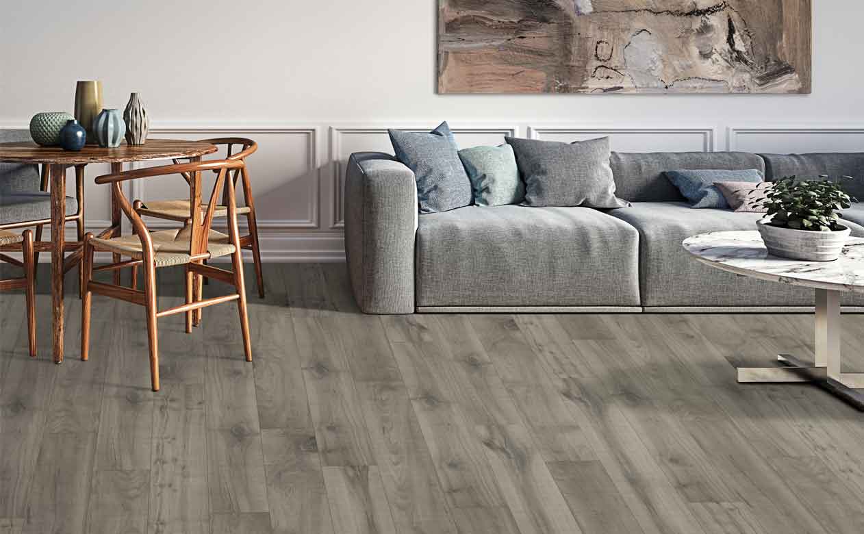 gray wood look laminate floors in living area with wood table and gray sofa